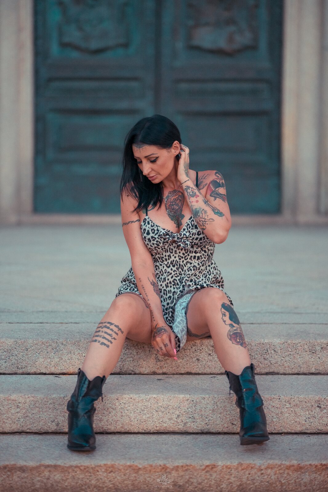 Woman in denim shorts and sturdy black boots ending above the ankle